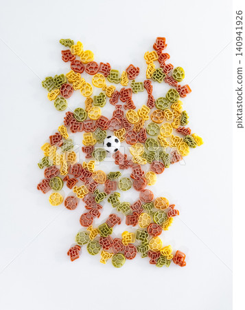 Shape of Germany arranged with colorful pasta pieces and a small soccer ball, forming a playful tribute to the football culture. Shape of Germany arranged with colorful pasta pieces and a small soccer ball, forming a playful tribute to the football culture. 140941926