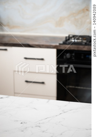 A bright kitchen with a stove and stone countertop in a minimalist style A bright kitchen with a stove and stone countertop in a minimalist style 140942089