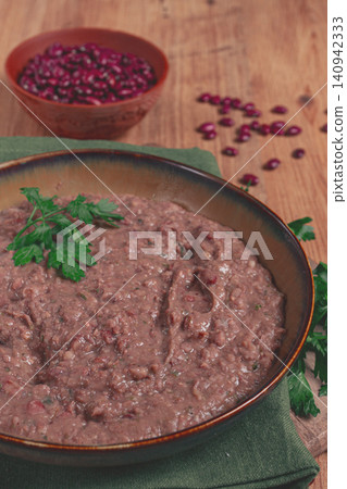 Red bean lobio,a traditional Georgian dish, on a wooden table, homemade, 140942333
