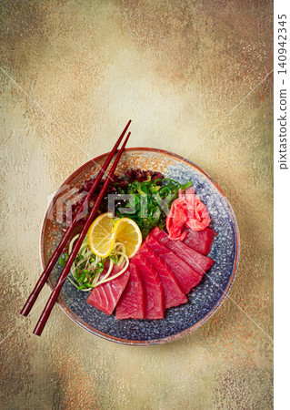 tuna sashimi with daikon and wakame salad, pickled ginger, in a bowl, 140942345
