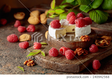 Camembert cheese with fresh raspberries and walnuts. Camembert cheese with fresh raspberries and walnuts. 140942568