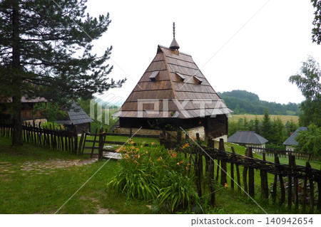 Traditional wooden cottages in the open-air museum of Sirogojno, Serbia, on a rainy summer day Traditional wooden cottages in the open-air museum of Sirogojno, Serbia, on a rainy summer day 140942654