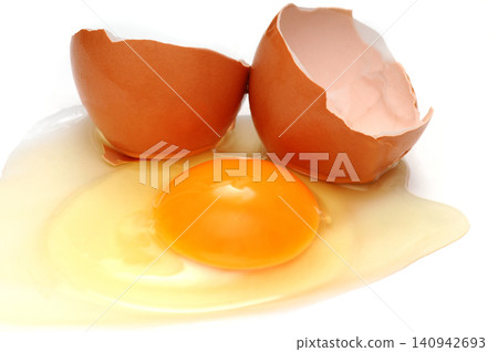 Broken egg with shells on white background Broken egg with shells on white background 140942693