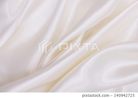 Smooth elegant white silk or satin luxury cloth texture as wedding background. Luxurious background design Smooth elegant white silk or satin luxury cloth texture as wedding background. Luxurious background design 140942725