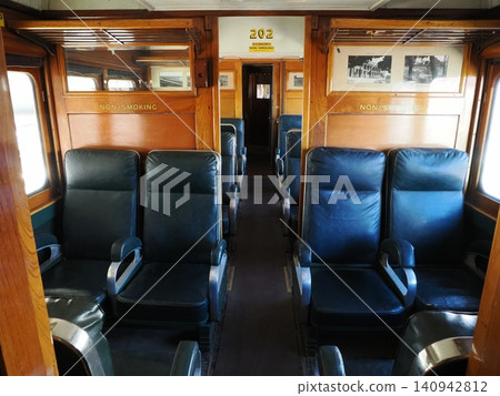 A Pullman passenger car at the Sulfide Street Railway History Museum—a quiet interior space with wooden decor and leather seats. A Pullman passenger car at the Sulfide Street Railway History Museum—a quiet interior space with wooden decor and leather seats. 140942812