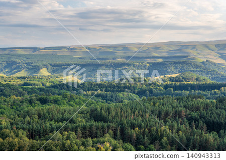 Layers of green mountains and hills in the haze during sunset. Panoramic View of Green hills and Meadow. Layers of green mountains and hills in the haze during sunset. Panoramic View of Green hills and Meadow. 140943313
