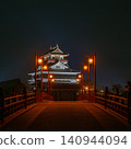 A night view of Kiyosu Castle: A fantastical scene with a red bridge and lanterns lit up. 140944094