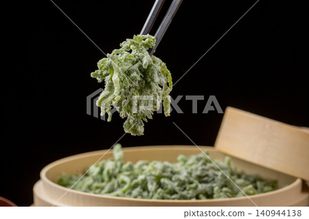 Chinese steamed flour coated crown daisy garland chrysanthemum vegetables with garlic sauce Chinese steamed flour coated crown daisy garland chrysanthemum vegetables with garlic sauce 140944138