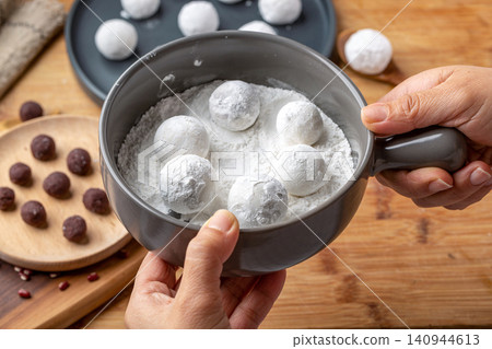 raw sweet rice balls with red bean fillings, unbaked Chinese Tangyuan mochi before cooking raw sweet rice balls with red bean fillings, unbaked Chinese Tangyuan mochi before cooking 140944613
