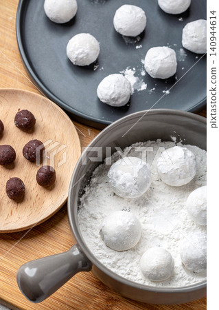 raw sweet rice balls with red bean fillings, unbaked Chinese Tangyuan mochi before cooking raw sweet rice balls with red bean fillings, unbaked Chinese Tangyuan mochi before cooking 140944614