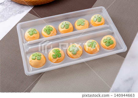 frozen raw persimmon shaped sweet rice balls, uncooked orange Tangyuan with black sesame filling for Chinese New Year frozen raw persimmon shaped sweet rice balls, uncooked orange Tangyuan with black sesame filling for Chinese New Year 140944663