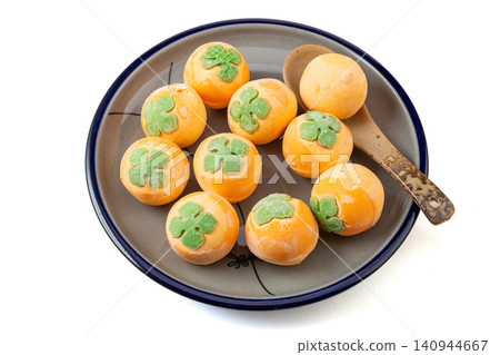 frozen raw persimmon shaped sweet rice balls, uncooked orange Tangyuan with black sesame filling for Chinese New Year frozen raw persimmon shaped sweet rice balls, uncooked orange Tangyuan with black sesame filling for Chinese New Year 140944667