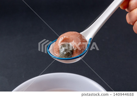 cooked red sorghum sweet rice balls with rich black sesame filling, healthy whole grain Chinese Tangyuan dessert cooked red sorghum sweet rice balls with rich black sesame filling, healthy whole grain Chinese Tangyuan dessert 140944688