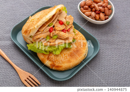 chinese sesame flatbread sandwich stuffed with spicy vegetarian chicken wings, traditional street food burger 140944875