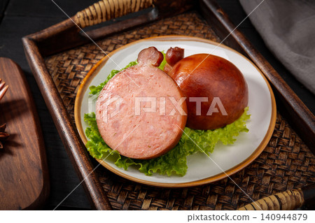 cut section of Chinese smoked pine nut pork sausage, sliced Songren Xiaodu showing rich meat texture 140944879