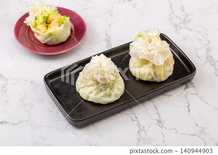 traditional Chinese paper skin shumai dumplings, steamed thin wrapper Siu Mai with savory glutinous rice filling 140944903