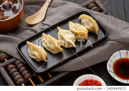 chinese traditional steamed dumplings, cooked Shaxian snacks Jiaozi with savory pork filling, authentic asian dim sum chinese traditional steamed dumplings, cooked Shaxian snacks Jiaozi with savory pork filling, authentic asian dim sum 140944915