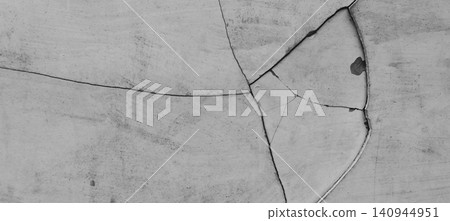 Abstract background with a cracked concrete wall texture in monochrome tones. Abstract background with a cracked concrete wall texture in monochrome tones. 140944951