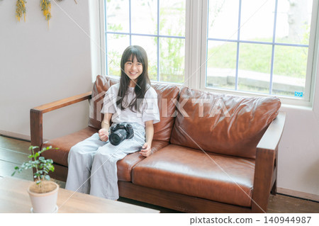 A young girl with a camera 140944987