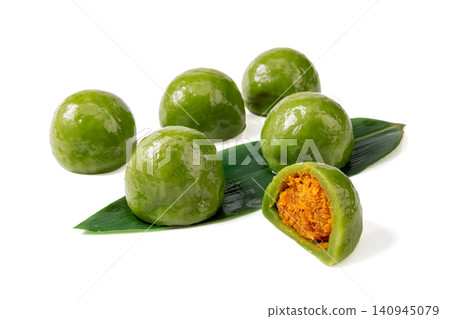 salted egg yolk and meat floss green rice ball, cut Qingtuan mochi showing savory filling on white background salted egg yolk and meat floss green rice ball, cut Qingtuan mochi showing savory filling on white background 140945079