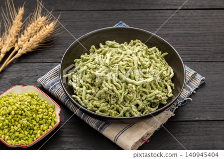 chinese traditional roasted green wheat noodles, handmade Nianzhuan with chili oil flavoring, healthy asian vegan food chinese traditional roasted green wheat noodles, handmade Nianzhuan with chili oil flavoring, healthy asian vegan food 140945404