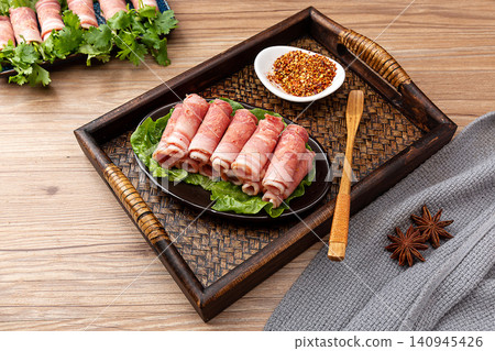 raw bacon rolls on skewers with spices, prepared for grilling Japanese Yakitori or Chinese barbecue. raw bacon rolls on skewers with spices, prepared for grilling Japanese Yakitori or Chinese barbecue. 140945426