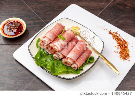 raw bacon rolls on skewers with spices, prepared for grilling Japanese Yakitori or Chinese barbecue. raw bacon rolls on skewers with spices, prepared for grilling Japanese Yakitori or Chinese barbecue. 140945427
