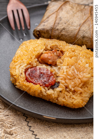 steamed glutinous rice with chicken and mushrooms wrapped in an aromatic lotus leaf. steamed glutinous rice with chicken and mushrooms wrapped in an aromatic lotus leaf. 140945455