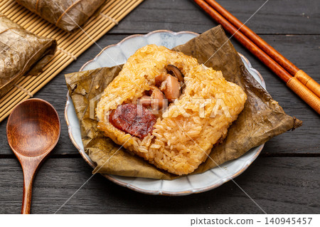 steamed glutinous rice with chicken and mushrooms wrapped in an aromatic lotus leaf. steamed glutinous rice with chicken and mushrooms wrapped in an aromatic lotus leaf. 140945457