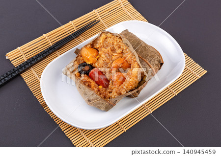 steamed glutinous rice with chicken and mushrooms wrapped in an aromatic lotus leaf. steamed glutinous rice with chicken and mushrooms wrapped in an aromatic lotus leaf. 140945459