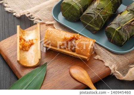 steamed sweet glutinous rice zongzi infused with candied honey dates and bamboo aroma. 140945460