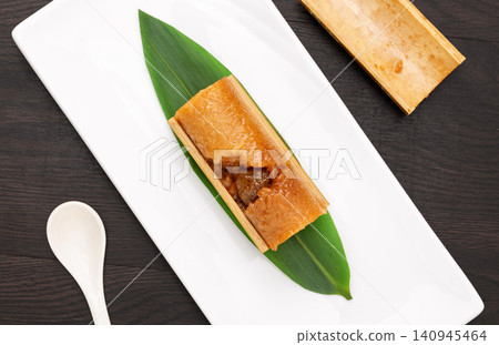 steamed sweet glutinous rice zongzi infused with candied honey dates and bamboo aroma. steamed sweet glutinous rice zongzi infused with candied honey dates and bamboo aroma. 140945464