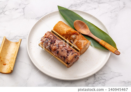 assortment of steamed sweet and savory zongzi dumplings featuring red bean, purple rice, and meat flavors. assortment of steamed sweet and savory zongzi dumplings featuring red bean, purple rice, and meat flavors. 140945467