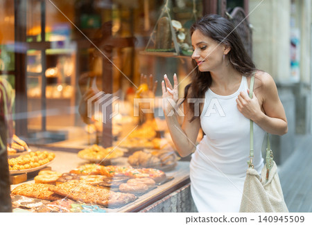 Young woman chooses baked goods in bakery 140945509