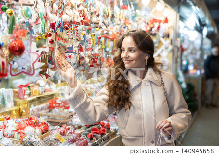Woman choosing Christmas decorations 140945658