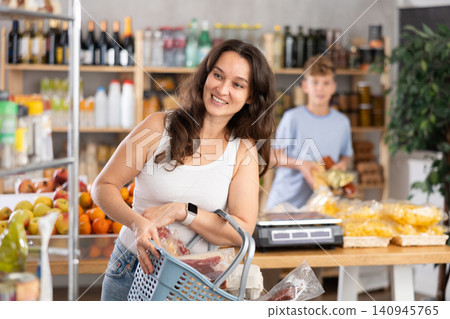 Woman chooses some food in store Woman chooses some food in store 140945765