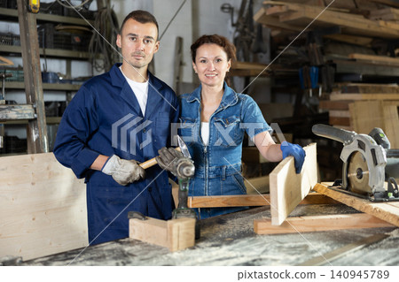 Man and woman posing in oak workshop 140945789