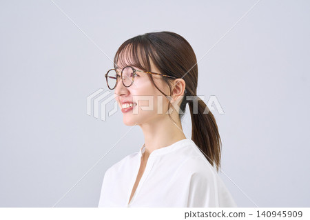 A smiling Japanese woman wearing glasses 140945909