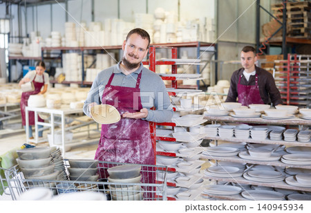 Young man posing with ceramic dishes 140945934