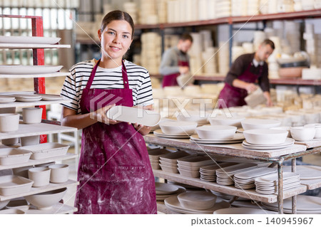 Young woman posing with ceramic blanks Young woman posing with ceramic blanks 140945967