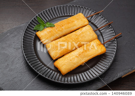deep fried crispy rice cake skewers garnished with fresh mint leaf. deep fried crispy rice cake skewers garnished with fresh mint leaf. 140946089