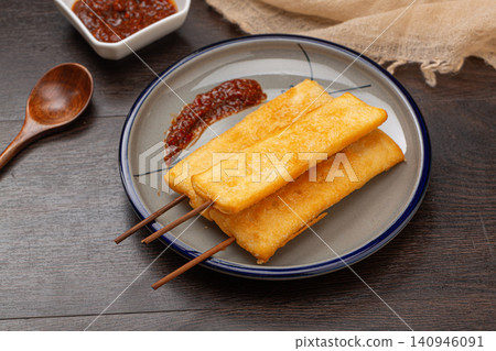 deep fried crispy rice cake skewers garnished with fresh mint leaf. deep fried crispy rice cake skewers garnished with fresh mint leaf. 140946091