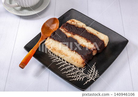 layered sweet rice cake with red bean paste filling. layered sweet rice cake with red bean paste filling. 140946106