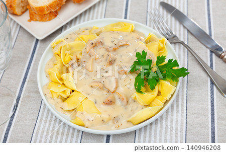 Ravioli with mushroom sauce served on platter Ravioli with mushroom sauce served on platter 140946208