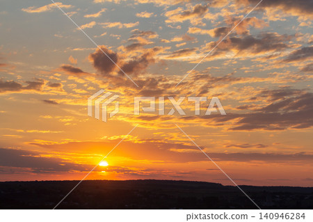 Sunset sky covered with orange puffy clouds in the evening. Sunset sky covered with orange puffy clouds in the evening. 140946284