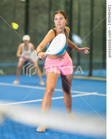 Sportive woman and other members engaged in Padel Tennis in indoor court of tennis club Sportive woman and other members engaged in Padel Tennis in indoor court of tennis club 140946481