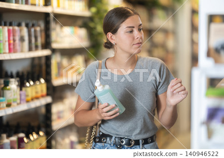 Female shopper choosing organic personal care products in store 140946522