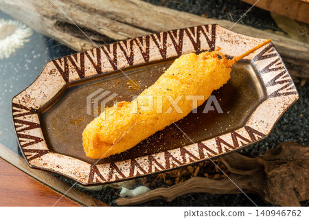 Baby corn skewers with the husks still on Baby corn skewers with the husks still on 140946762