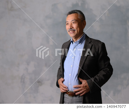 A man posing in a suit A man posing in a suit 140947077