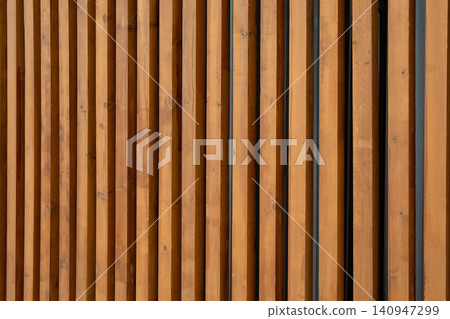 Vertical wooden slats form a stylish backdrop in a contemporary setting Vertical wooden slats form a stylish backdrop in a contemporary setting 140947299